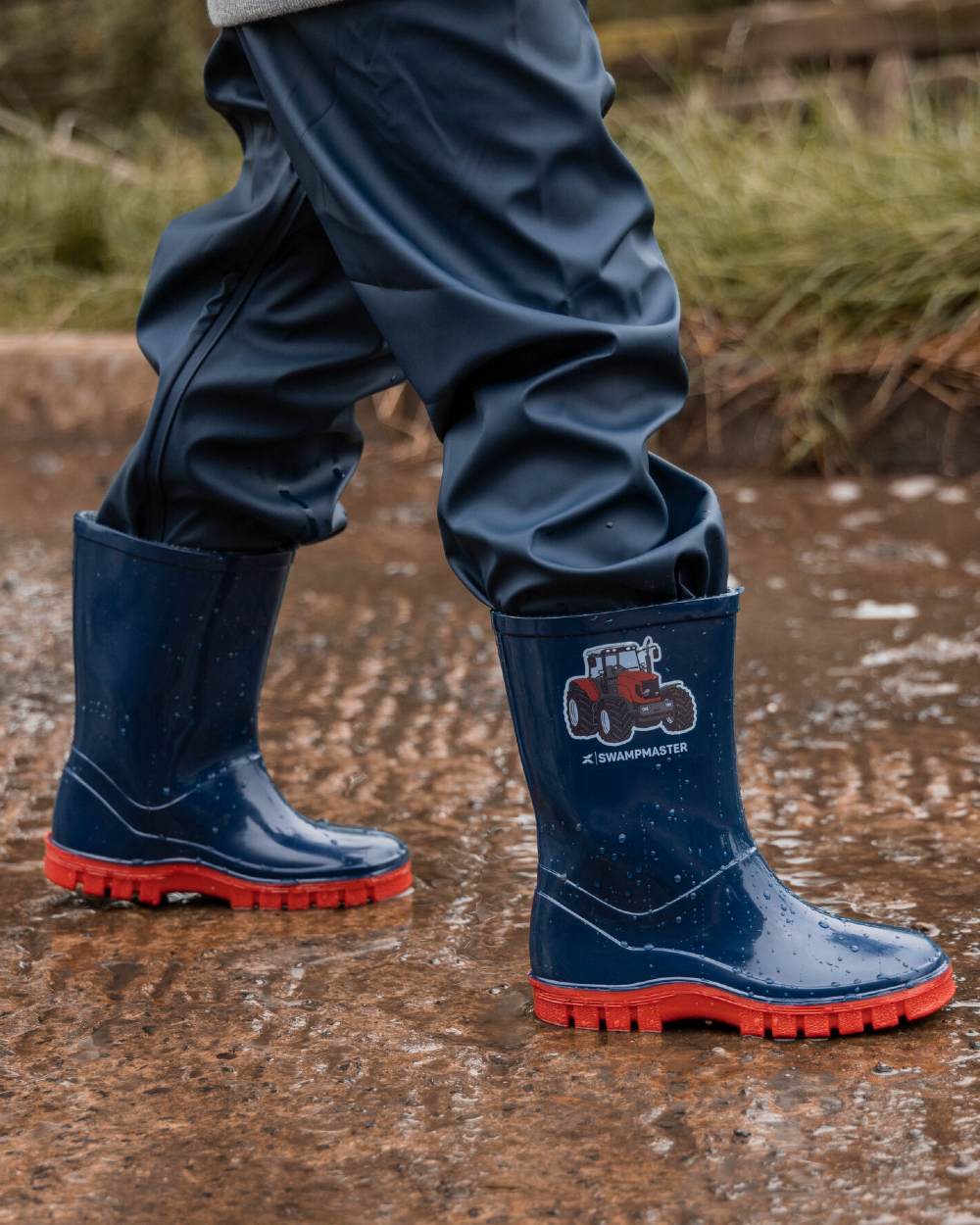 Navy Red Coloured Xpert Childrens Swampmaster Tractor Wellingtons on Outdoor Background