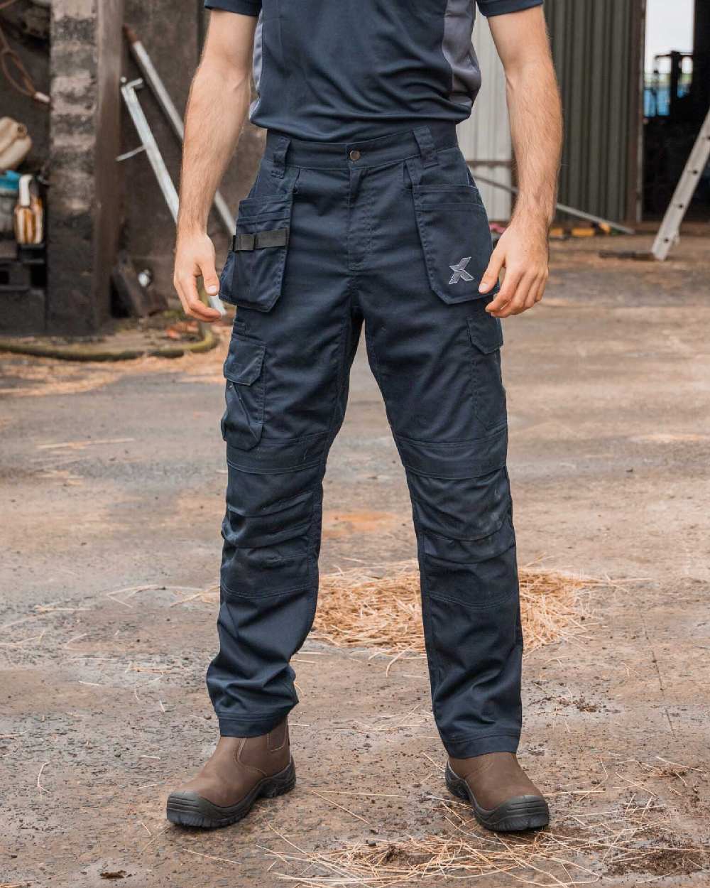 Navy Coloured Xpert Mens Core Work Trousers on Outdoor Background
