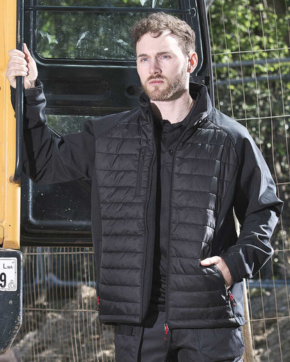 Man near digger wearing TuffStuff Snape Softshell Jacket with quilted front 