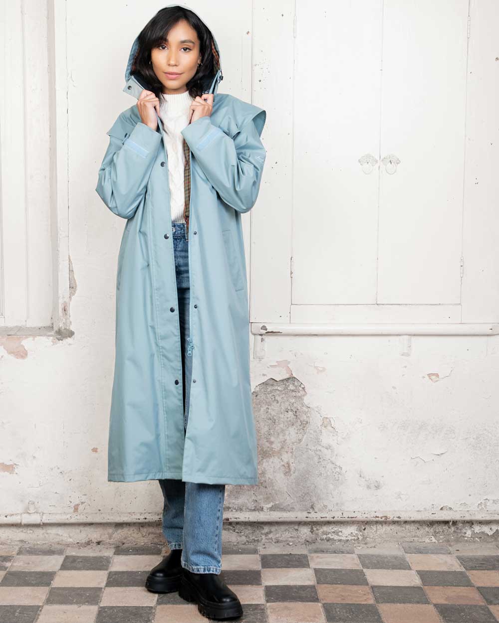 Smokey Blue coloured Jack Murphy Malvern Ladies Waterproof Bush Coat on wall background 