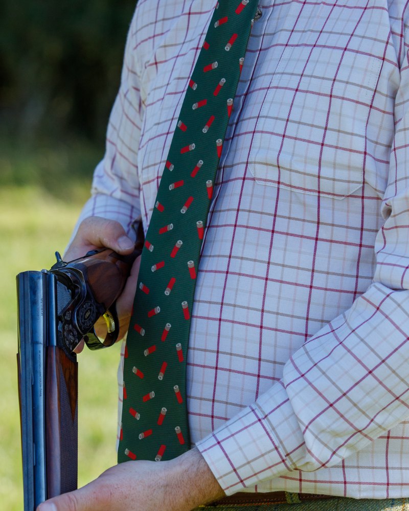 Green Jack Pyke shotgun cartridge tie worn with country check shirt outdoors