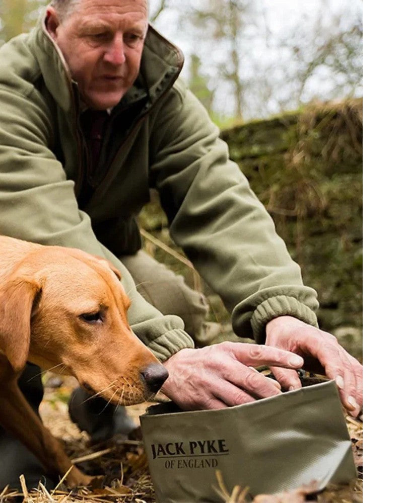 Man with dog using a collapsible Jack Pyke dog bowl outdoors