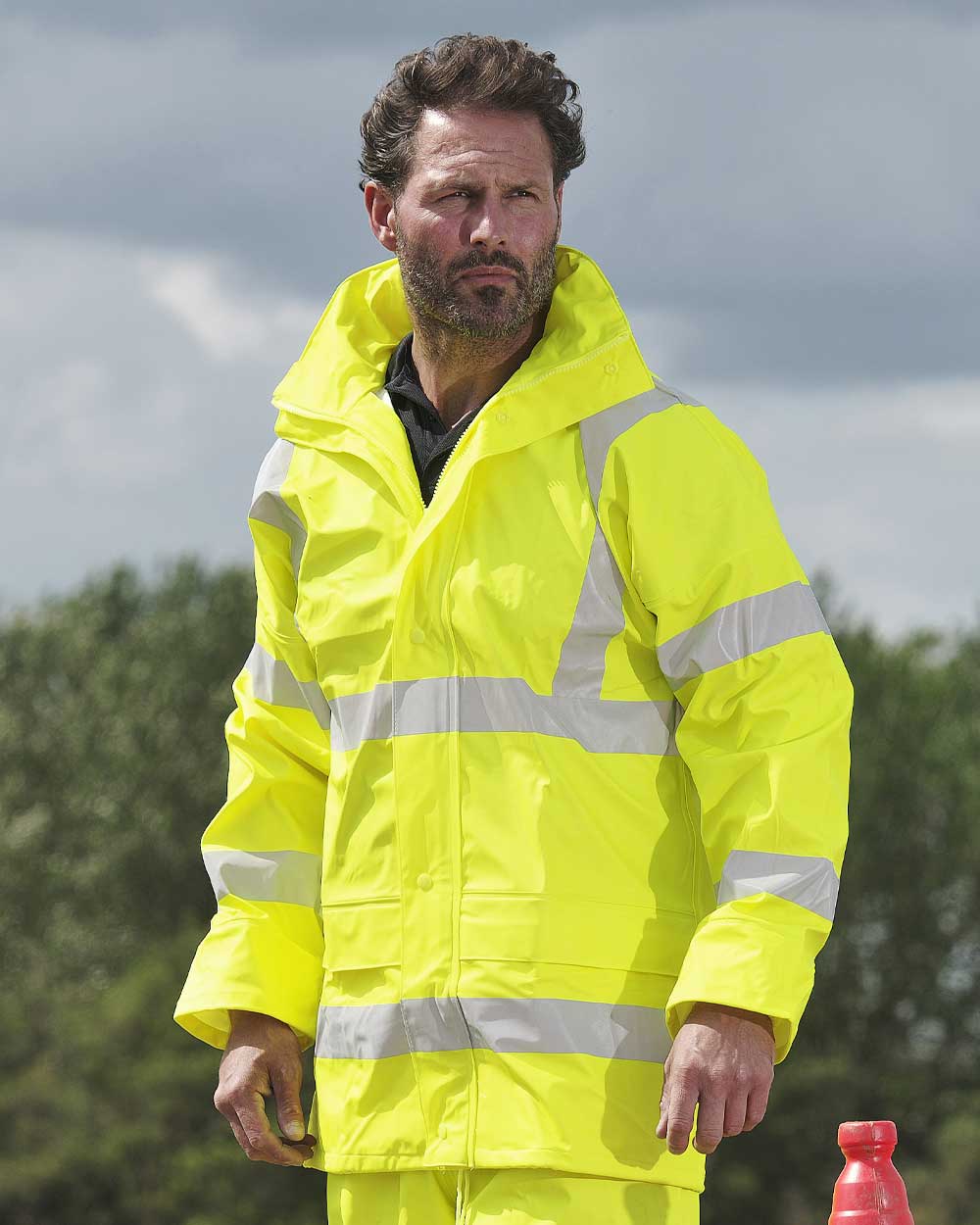 Man wearing Fort Air Reflex Waterproof Hi-vis Jacket in yellow with reflective strips