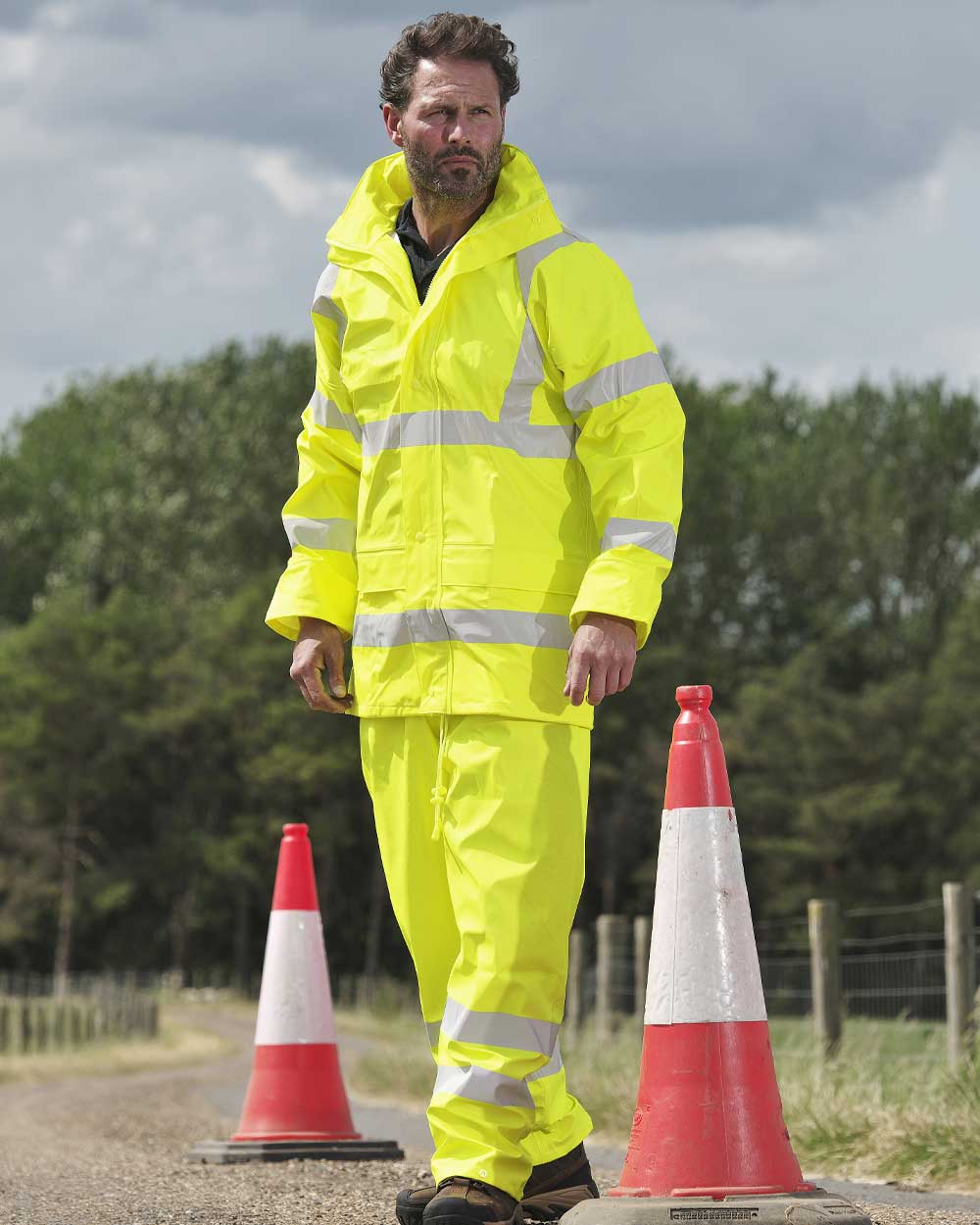 Man wearing Fort Mens Air Reflex Hi-Vis Trousers in yellow with Reflective strips