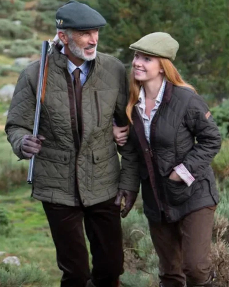 Two people wearing Percussion quilted jackets while walking outdoors in the countryside