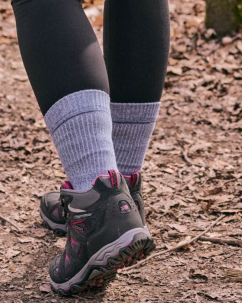 Person wearing HJ Hall walking socks with hiking shoes on a woodland trail