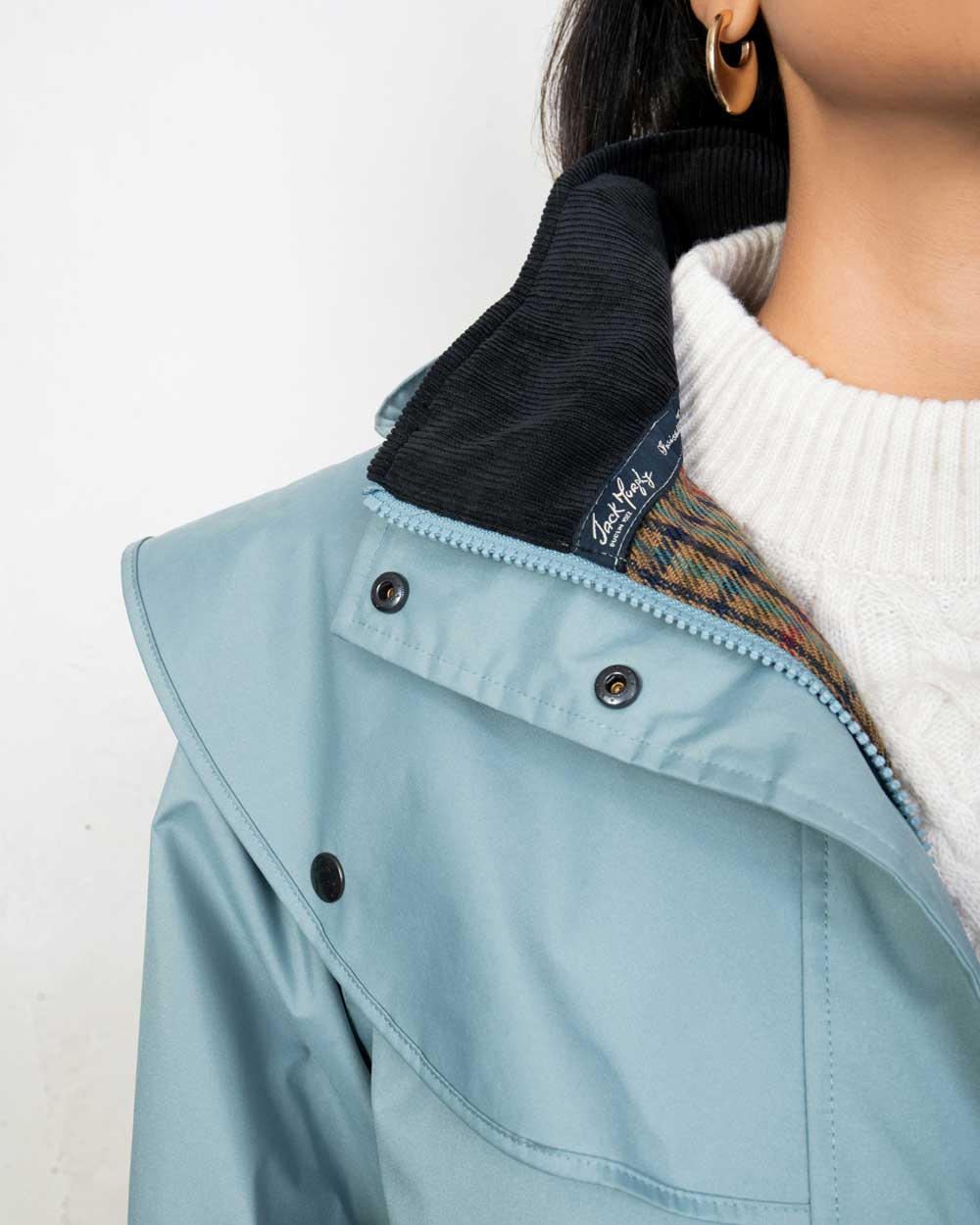 Smokey Blue coloured Jack Murphy Malvern Ladies Waterproof Bush Coat on wall background 