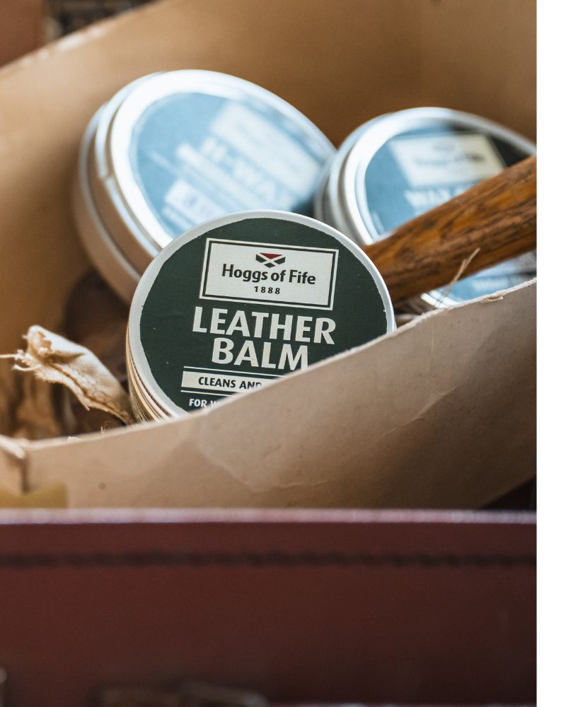 Hoggs of Fife leather balm tins displayed in a rustic storage tray