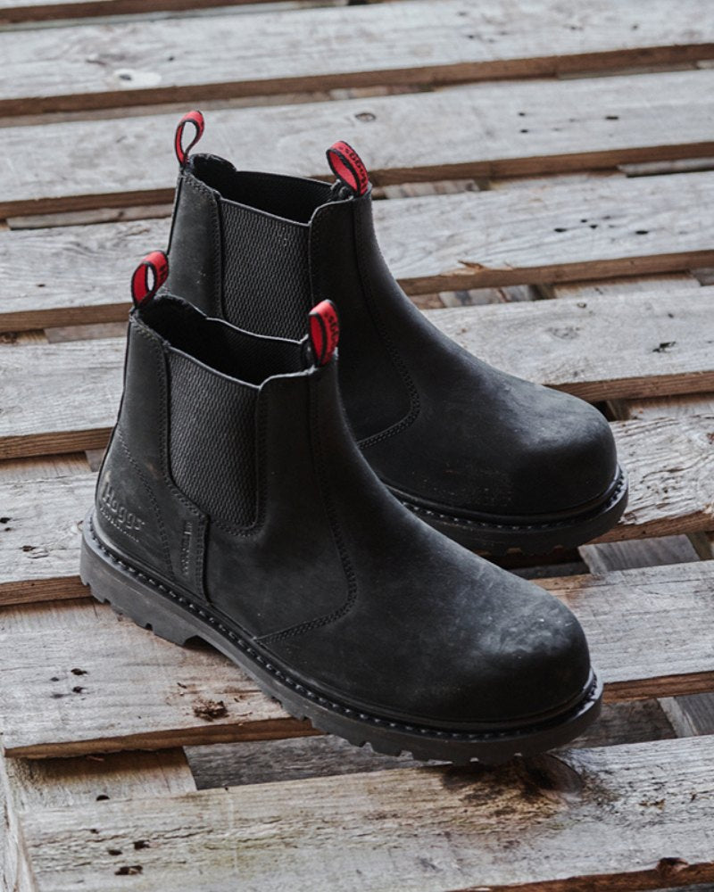 Pair of black Hoggs of Fife dealer boots on a wooden palette. 