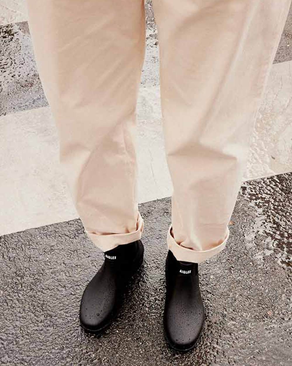Noir coloured Aigle Mens Carville M2 Ankle Wellingtons on street background 