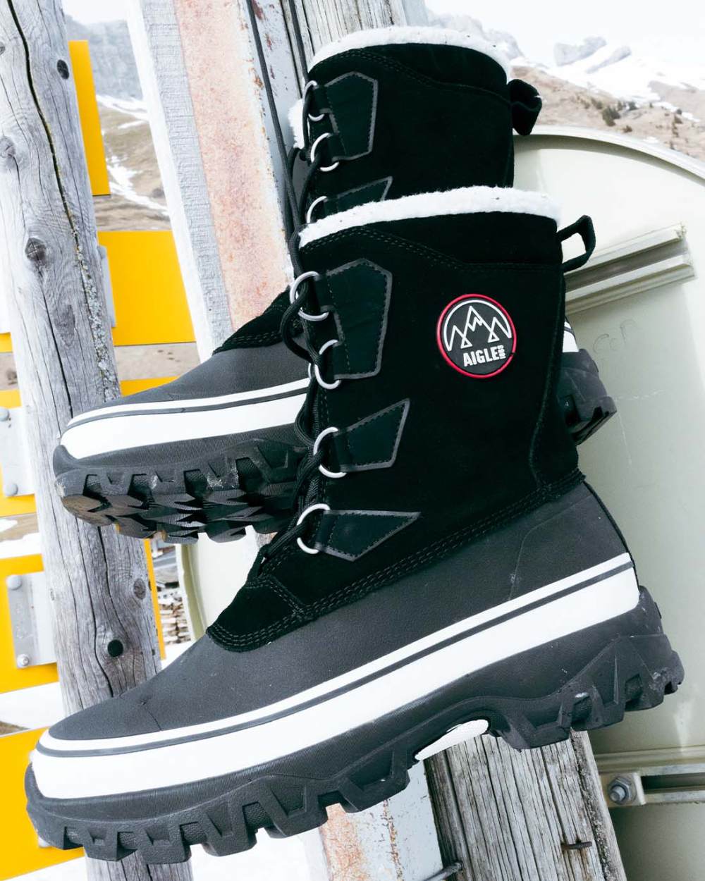 Noir coloured Aigle Mens Snow Boots on outdoor background 