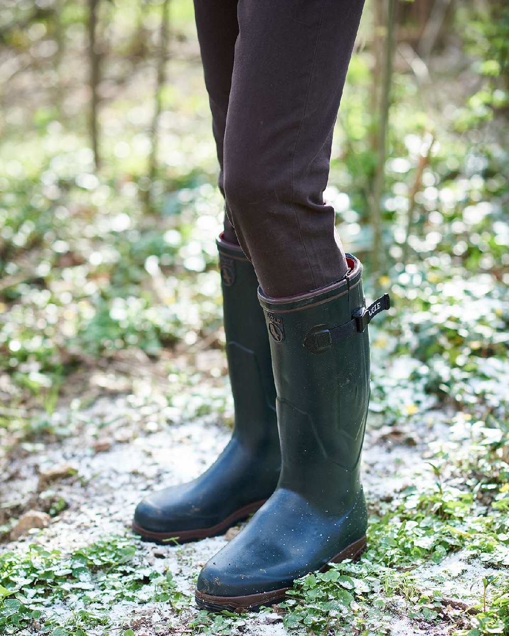 Bronze coloured Aigle Parcours 2 ISO Wellington Boots on forest background 