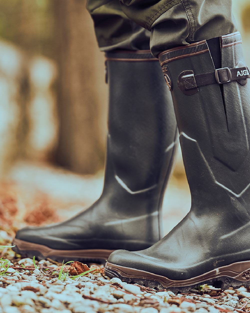 Brun coloured Aigle Parcours 2 ISO Wellington Boots on forest background 