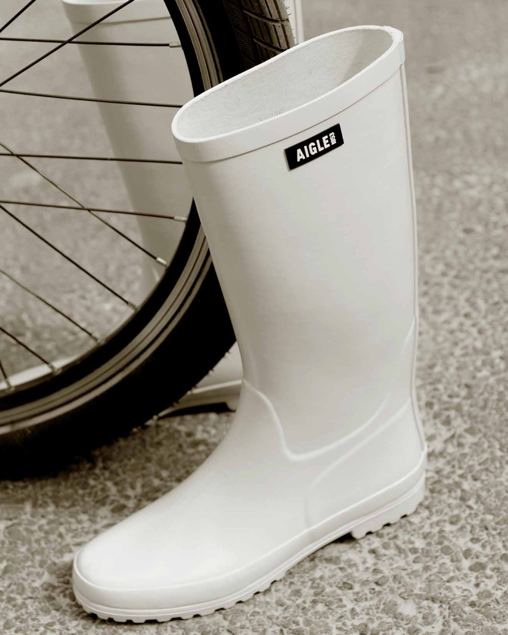 Sable coloured Aigle Womens Eliosa Wellingtons on street background 