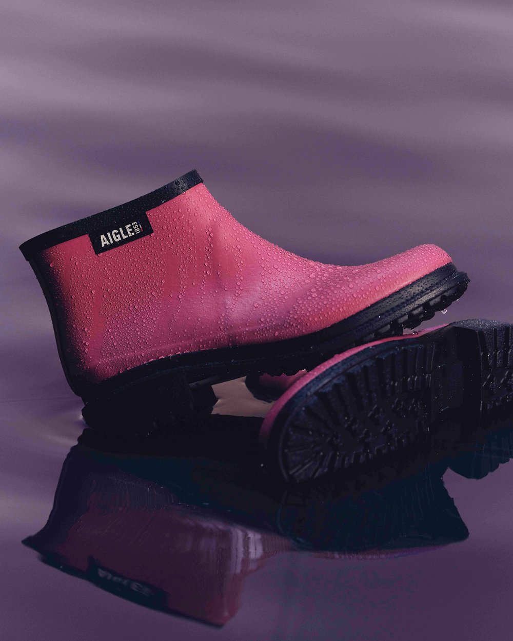 Raspberry FFL coloured Aigle Womens Fulfeel Low Rain Ankle Boots on glass background 