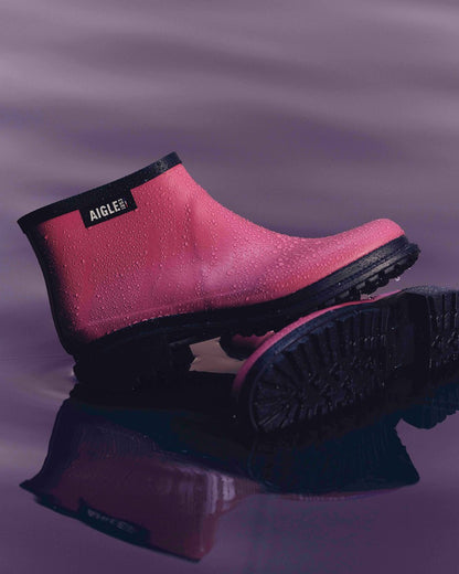 Raspberry FFL coloured Aigle Womens Fulfeel Low Rain Ankle Boots on glass background 