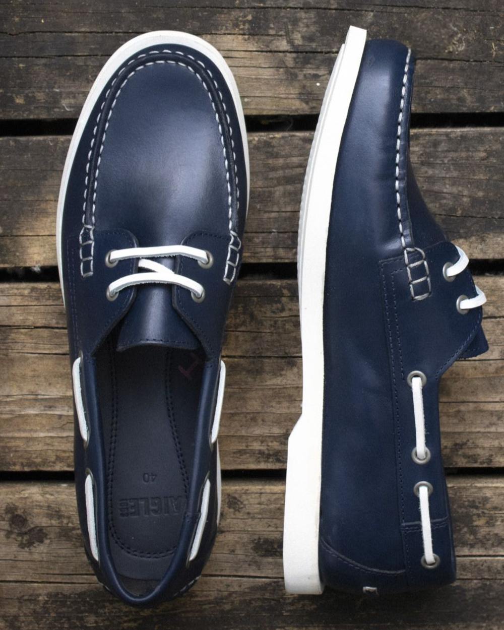 Marine coloured Aigle Womens Nubila Leather Deck Shoes on wood background 