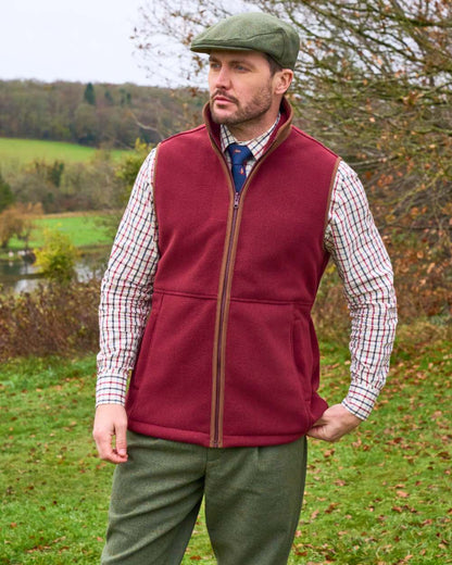 Bordeaux coloured Alan Paine Aylsham Fleece Gilet on forest background 
