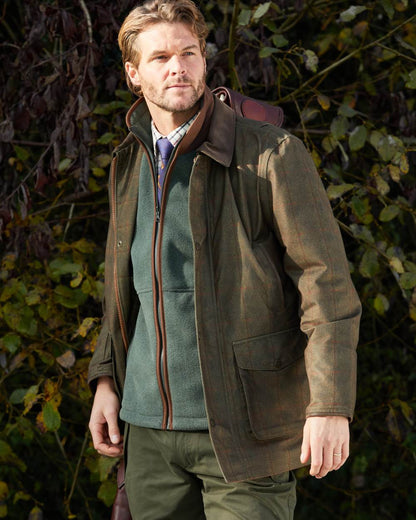 Cedar coloured Alan Paine Aylsham Fleece Gilet on leafy background 