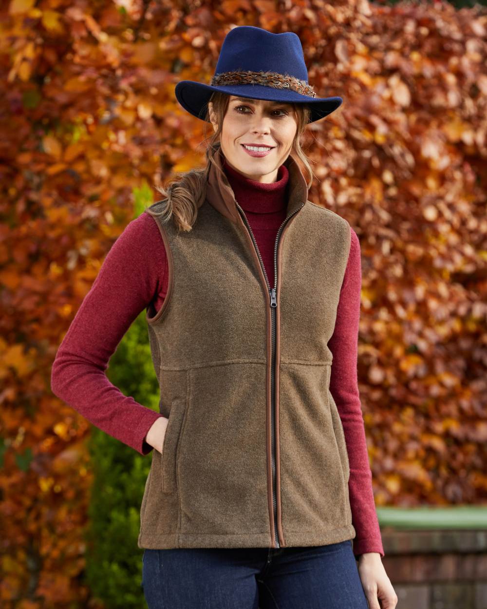 Pecan Coloured Alan Paine Aylsham Ladies Fleece Gilet on leafy background 