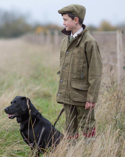 Lichen coloured Alan Paine Childrens Tweed Water Repellent Breeks on grassy background 