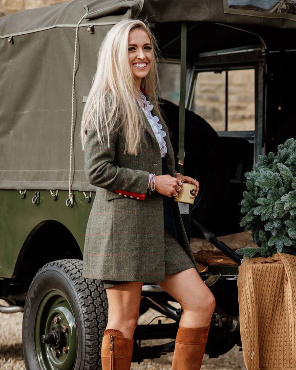 Heath coloured Alan Paine Combrook Ladies Mid Thigh Coat on jeep background 