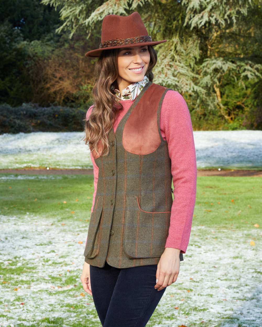 Willow coloured Alan Paine Combrook Ladies Tweed Shooting Waistcoat on forest background 