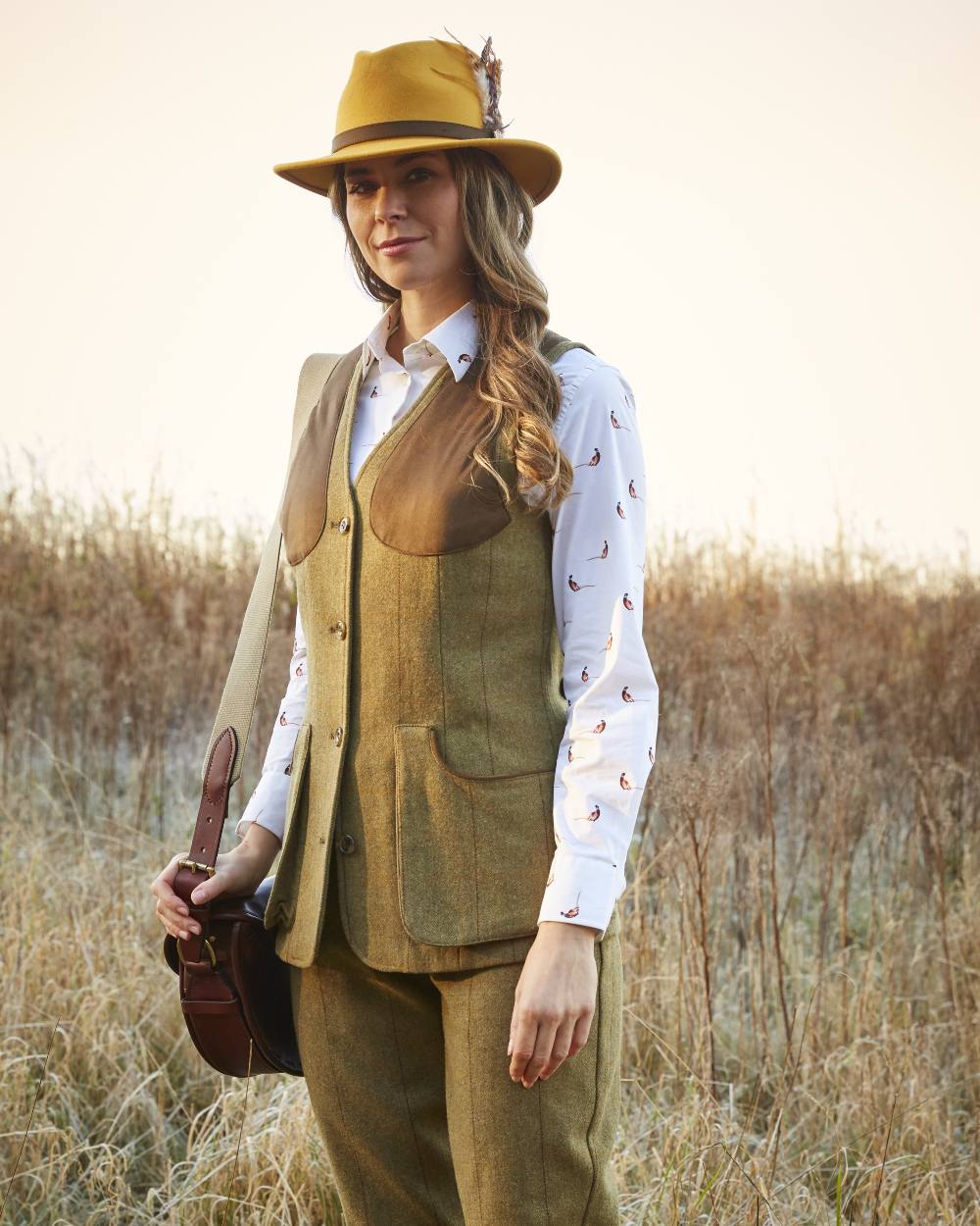 Grove coloured Alan Paine Combrook Ladies Tweed Shooting Waistcoat on field background 