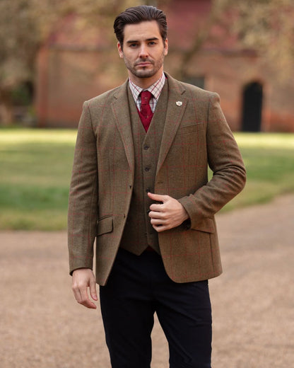 Sage coloured Alan Paine Combrook Mens Tweed Sports Blazer on blurry background 