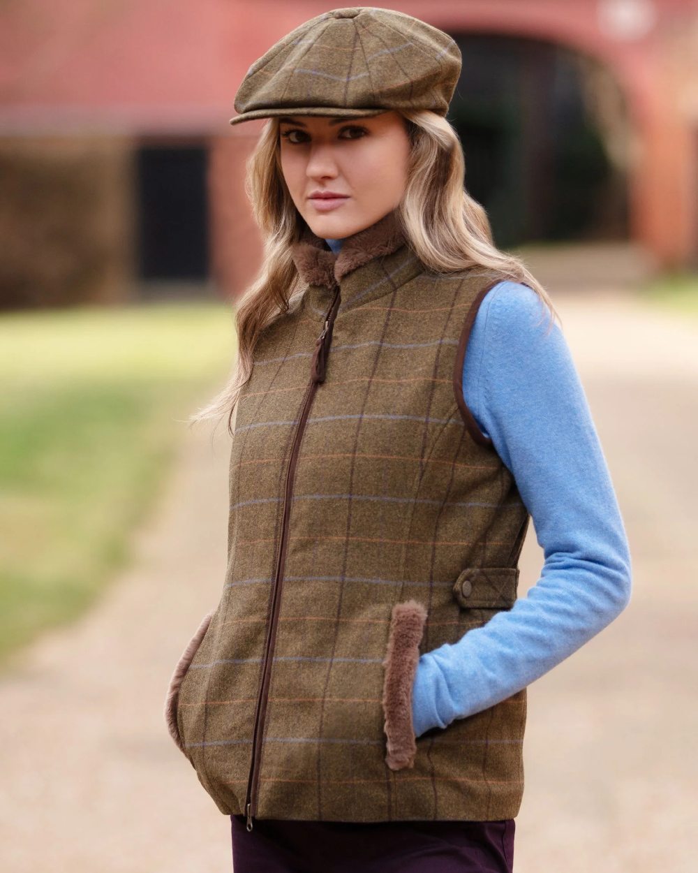 Hazel coloured Alan Paine Combrook Tweed Ladies Gilet on blurry background 