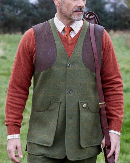 Maple coloured Alan Paine Combrook Tweed Shooting Waistcoat on forest background 