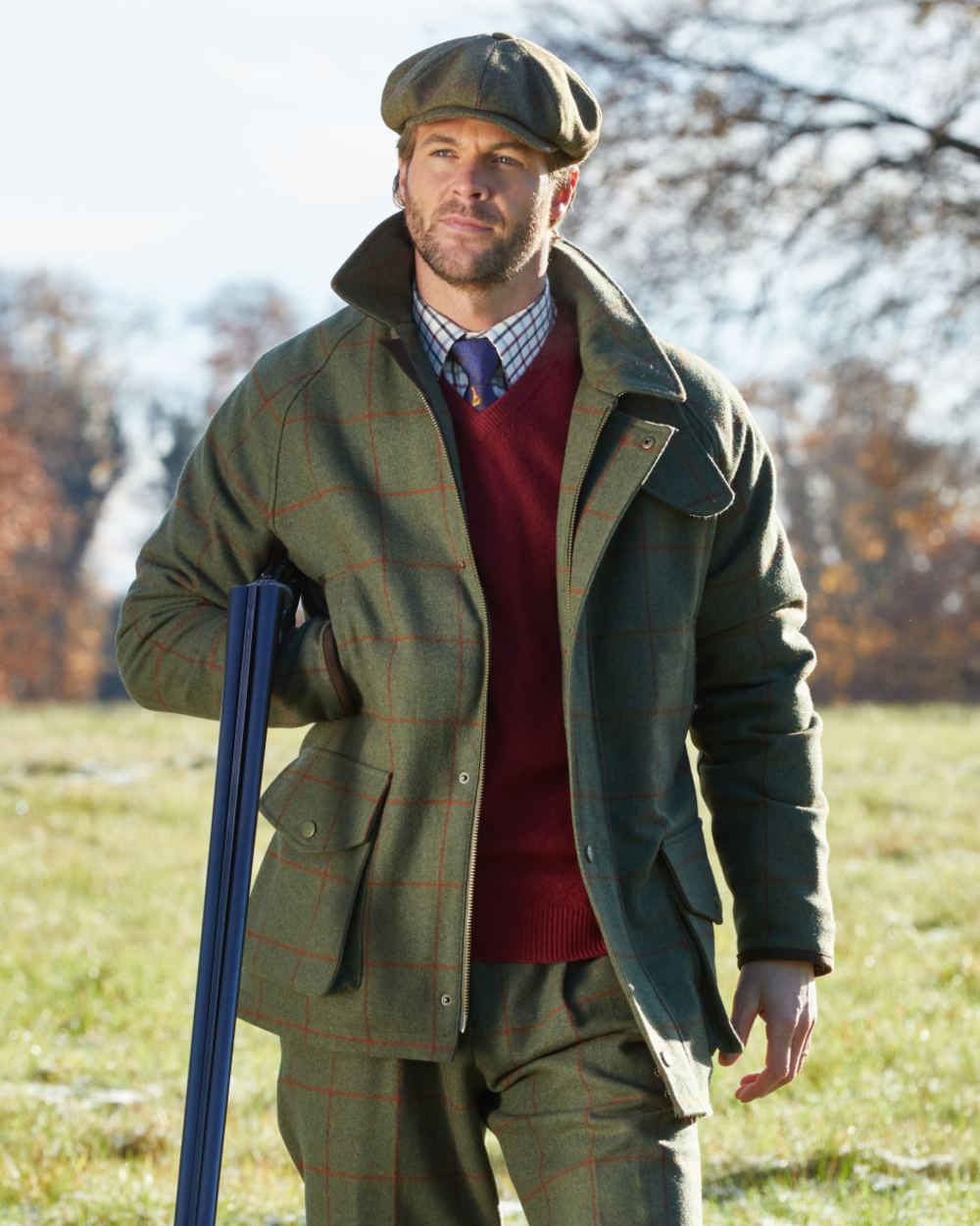 Reed coloured Alan Paine Combrook Tweed Waterproof Coat on forest background 