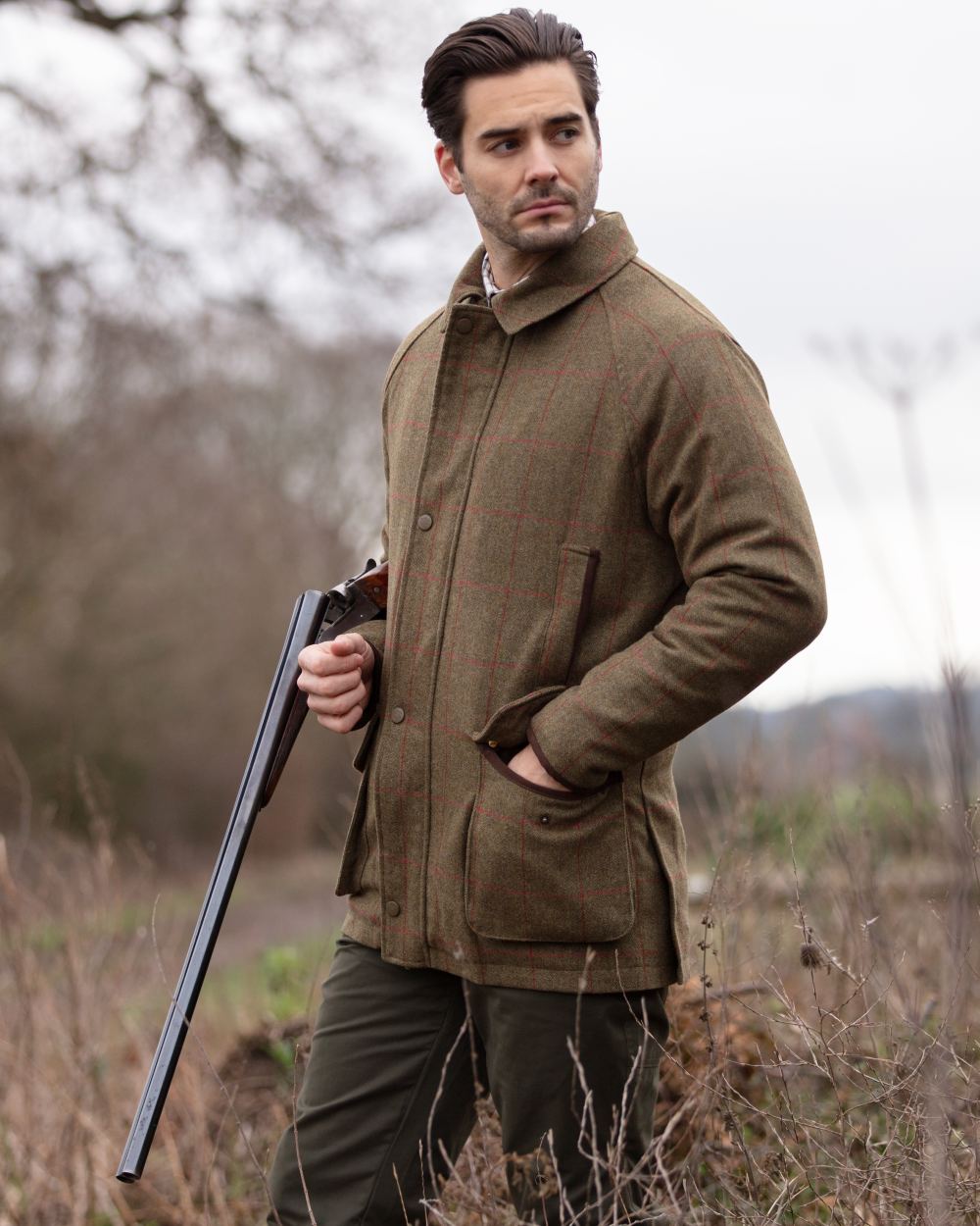 Sage coloured Alan Paine Combrook Tweed Waterproof Coat on forest background 
