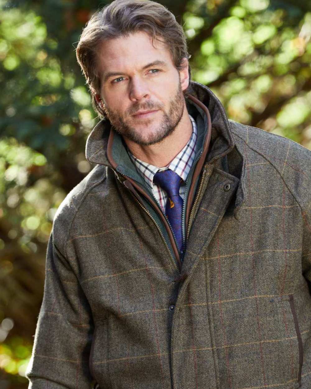 Teak coloured Alan Paine Combrook Tweed Waterproof Coat on forest background 