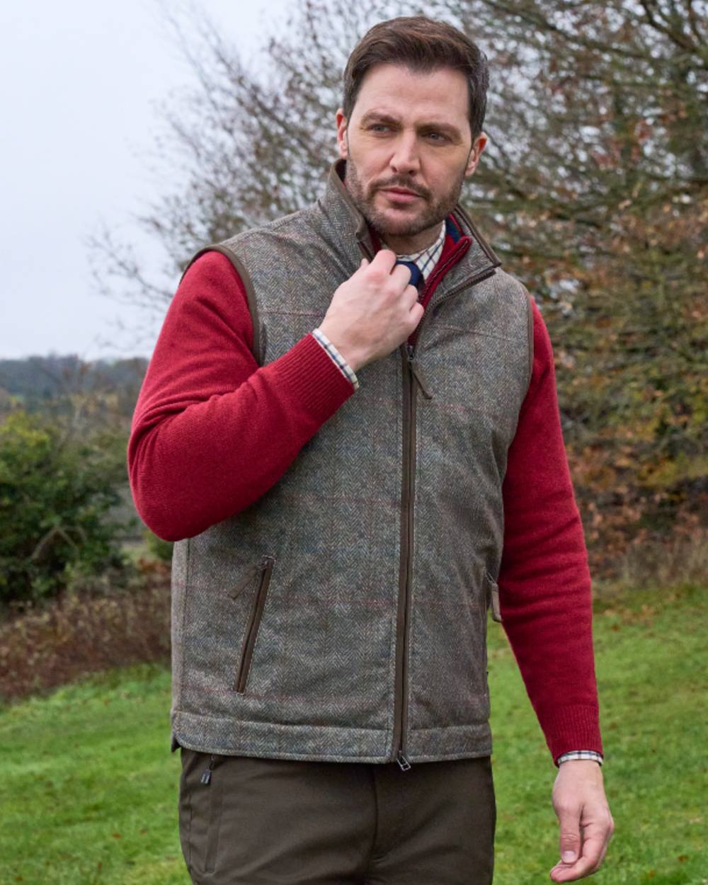 Ackley coloured Alan Paine Didsmere Mens Technical Tweed Gilet on forest background 