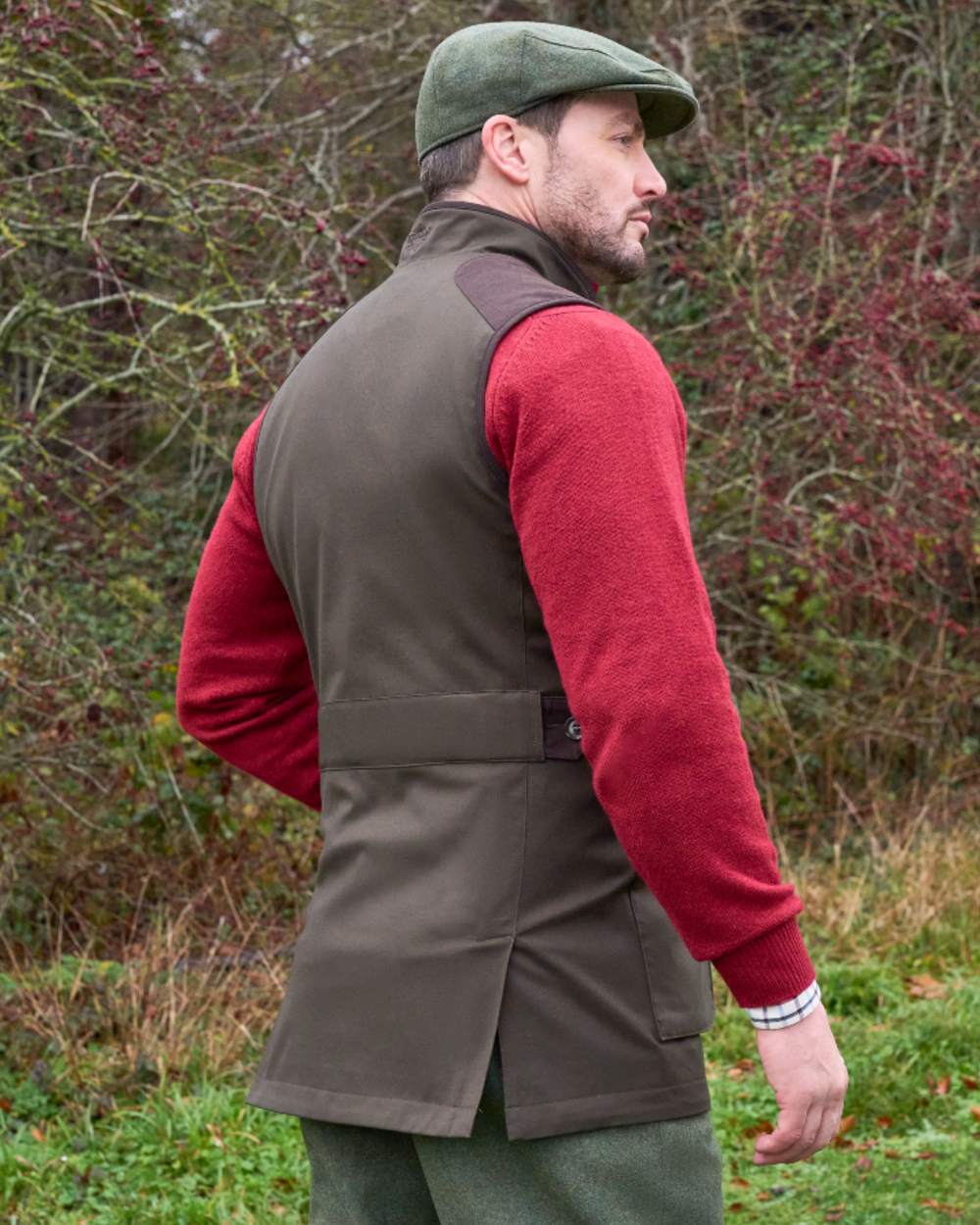 Olive coloured Alan Paine Didsmere Mens Technical Tweed Gilet on forest background 