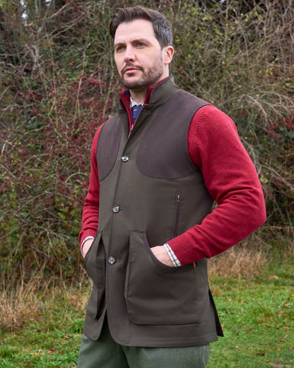 Olive coloured Alan Paine Didsmere Mens Technical Tweed Gilet on forest background 