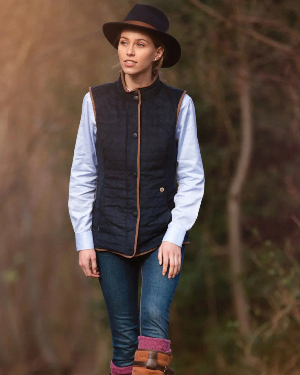 Dark Navy coloured Alan Paine Ladies Felwell Quilted Gilet on blurry background 