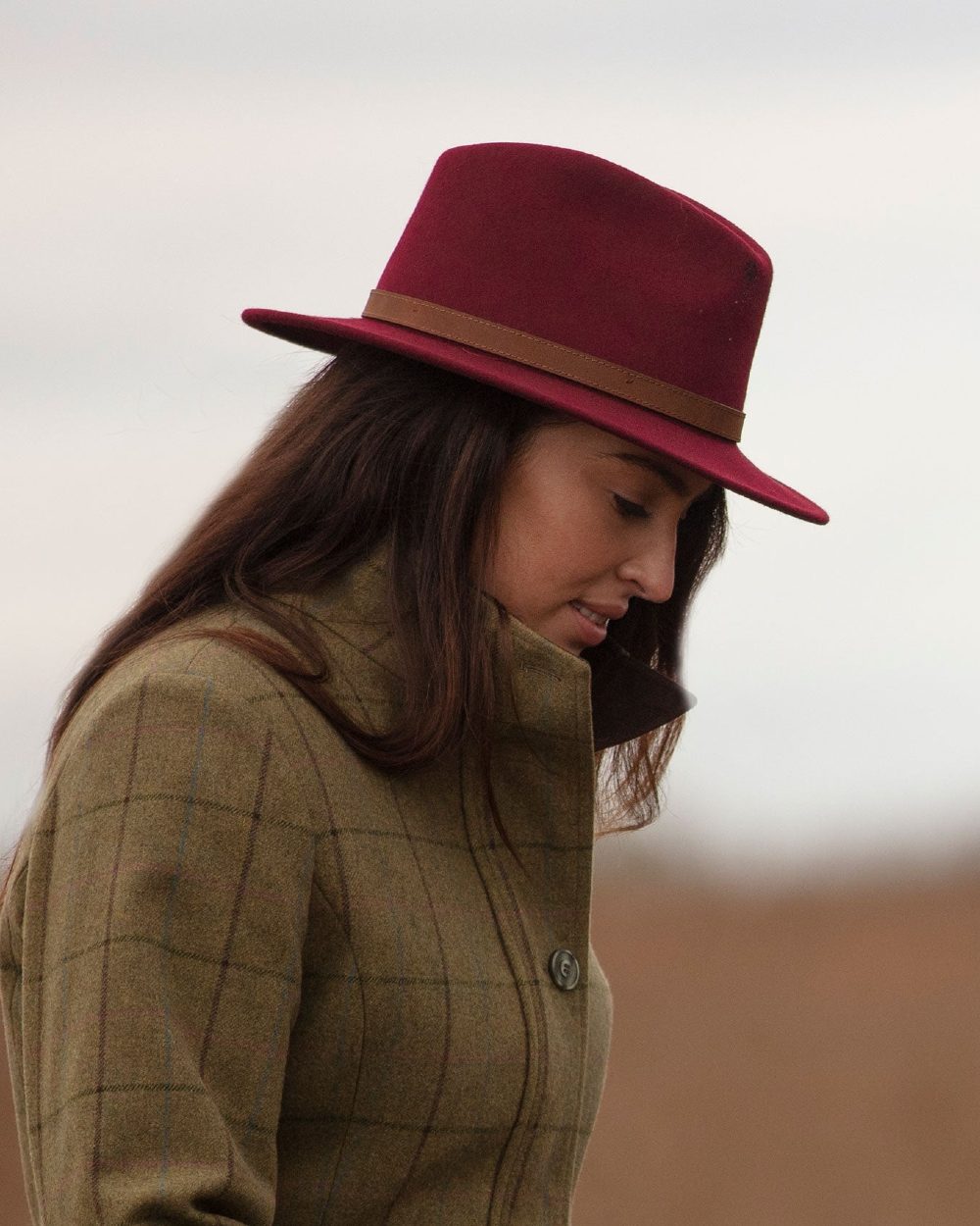 Wine coloured Alan Paine Ladies Richmond Felt Hat on blurry background 