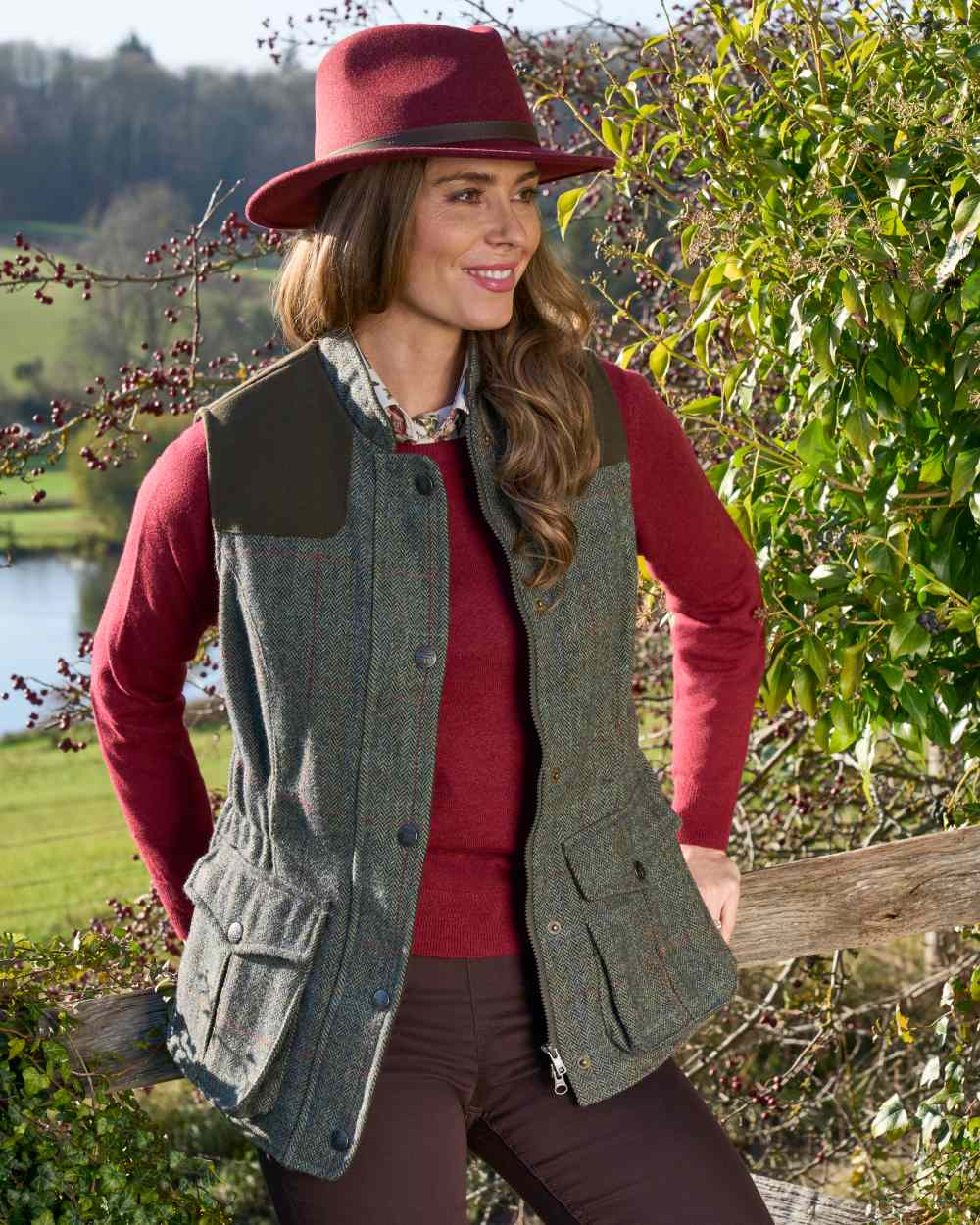 Juniper coloured Alan Paine Ladies Rutland Tweed Gilet on forest background 