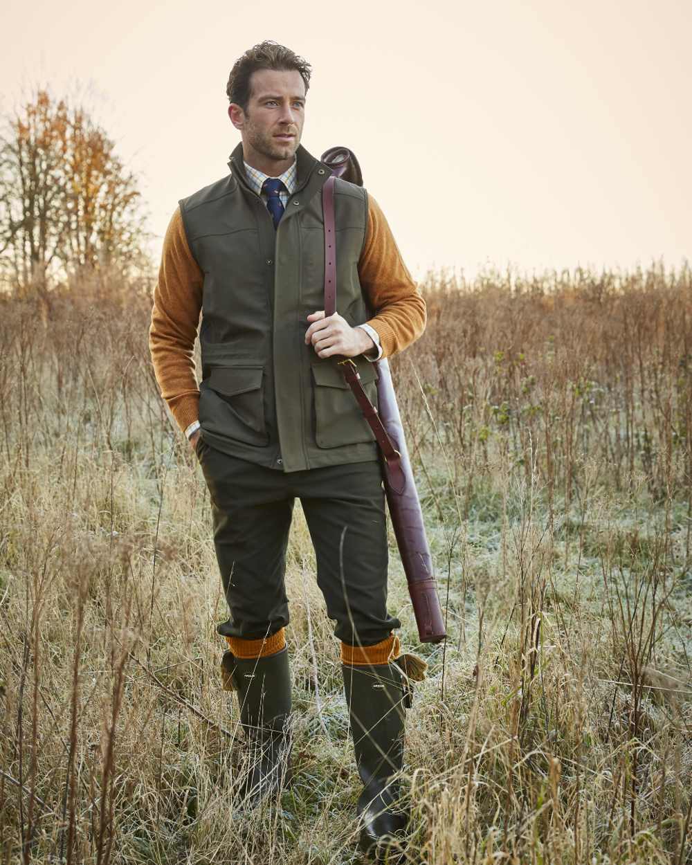 Olive coloured Alan Paine Lockwood Mens Shooting Waistcoat on field background 