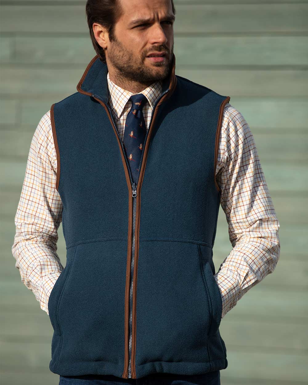 Man with tie and tattersall shirt wearing Alan Paine Aylsham Fleece Gilet in Blue Steel 