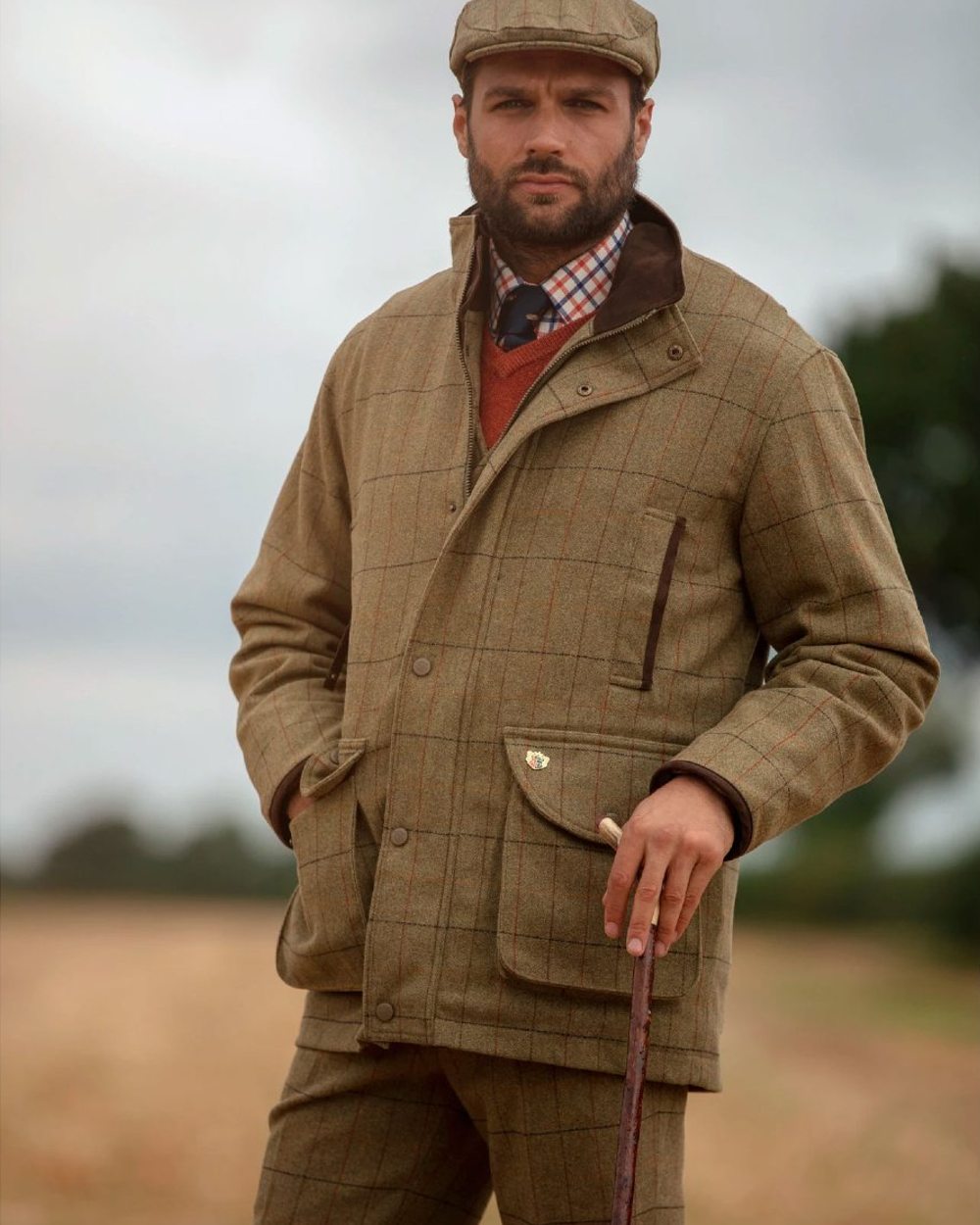 Elm coloured Alan Paine Mens Combrook Field Coat on blurry background 