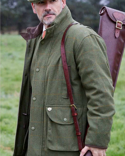 Maple coloured Alan Paine Mens Combrook Field Coat on blurry green background 