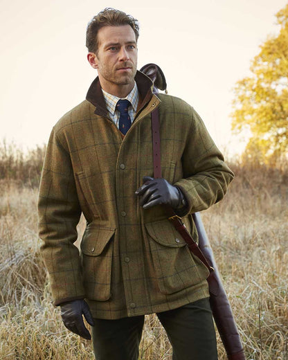 Thyme coloured Alan Paine Mens Combrook Field Coat on blurry forest background 