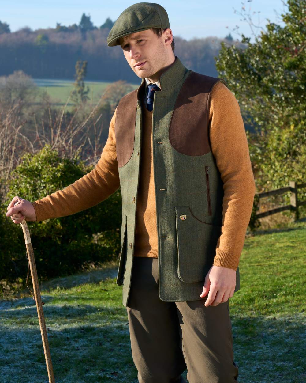 Mariner coloured Alan Paine Mens Combrook Tweed Shooting Gilet on forest background 