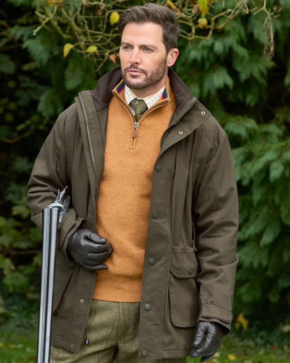 Olive coloured Alan Paine Mens Dunswell Field Coat on tree background 