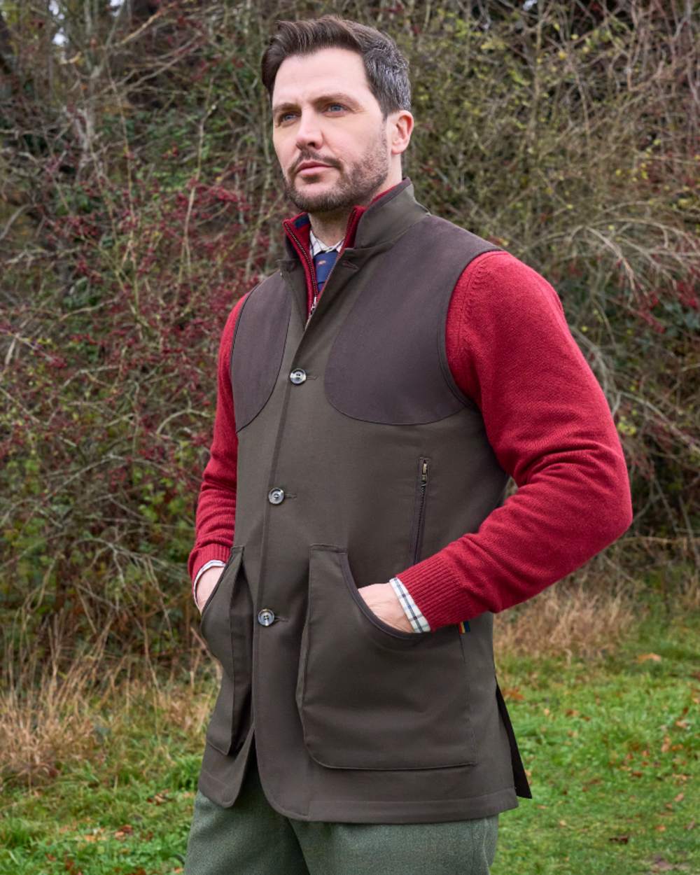Olive coloured Alan Paine Mens Dunswell Water Repellent Gilet on forest background 