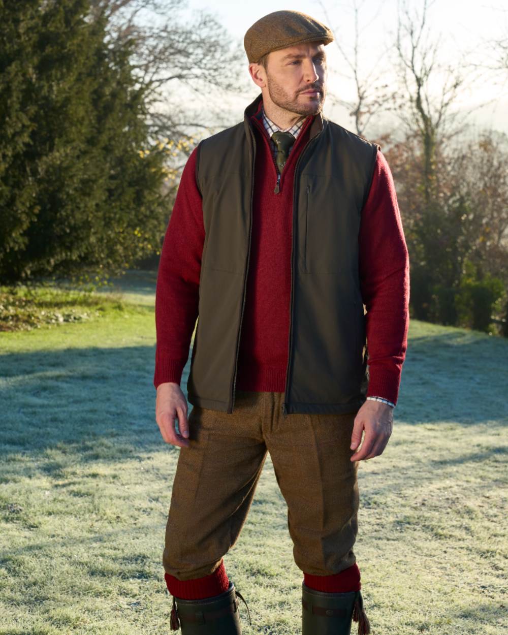 Olive coloured Alan Paine Mens Willsden Water Repellent Gilet on forest background 