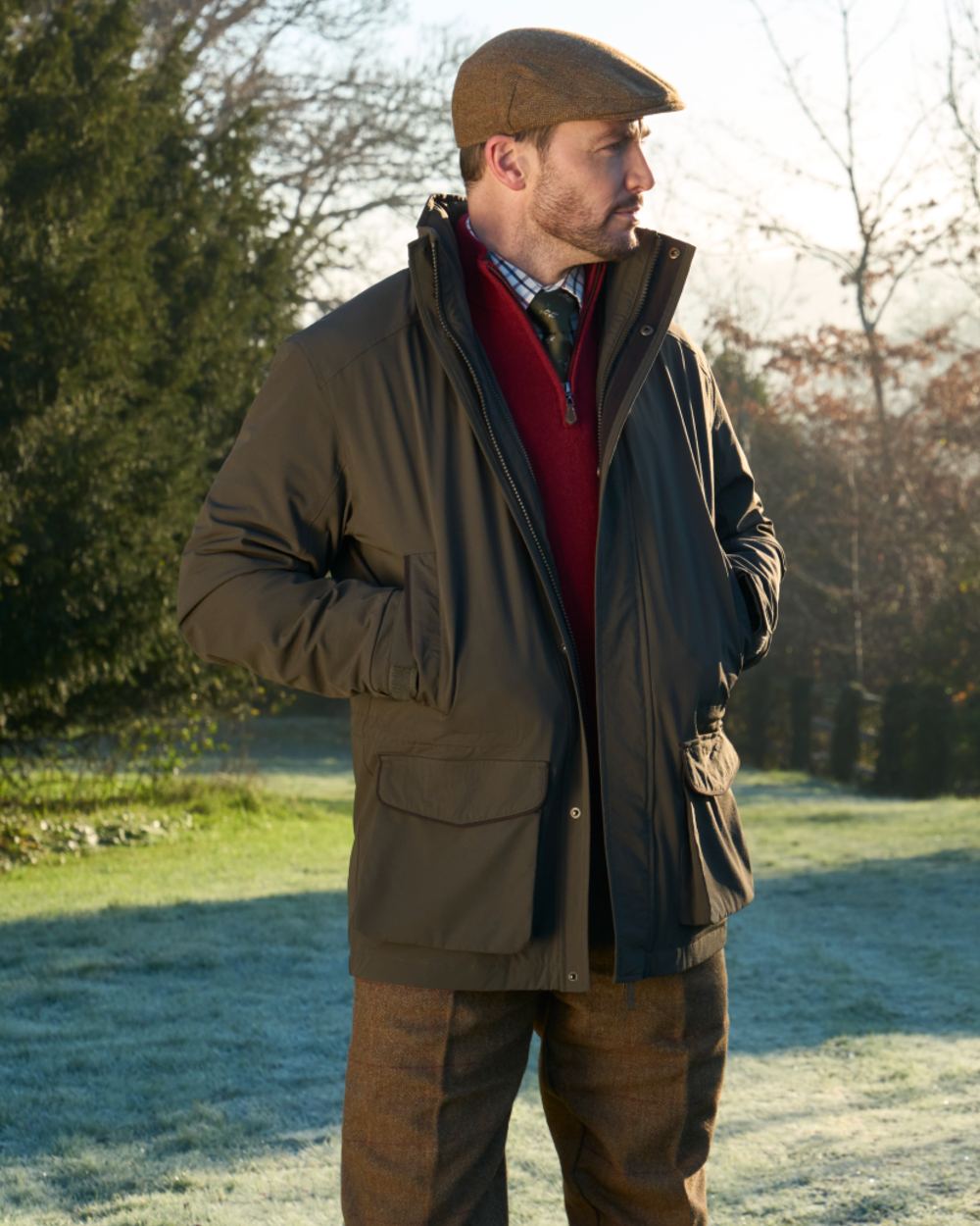 Olive coloured Alan Paine Mens Willsden Waterproof Coat on forest background 
